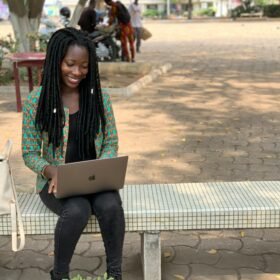 Nigerian university student using a laptop.